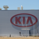 A man walks past the logo of Kia Motors at the manufacturing plant in Pesqueria, on the outskirts of Monterrey